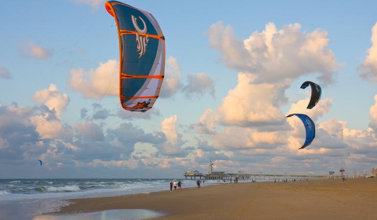 Kitesurfers op het strand